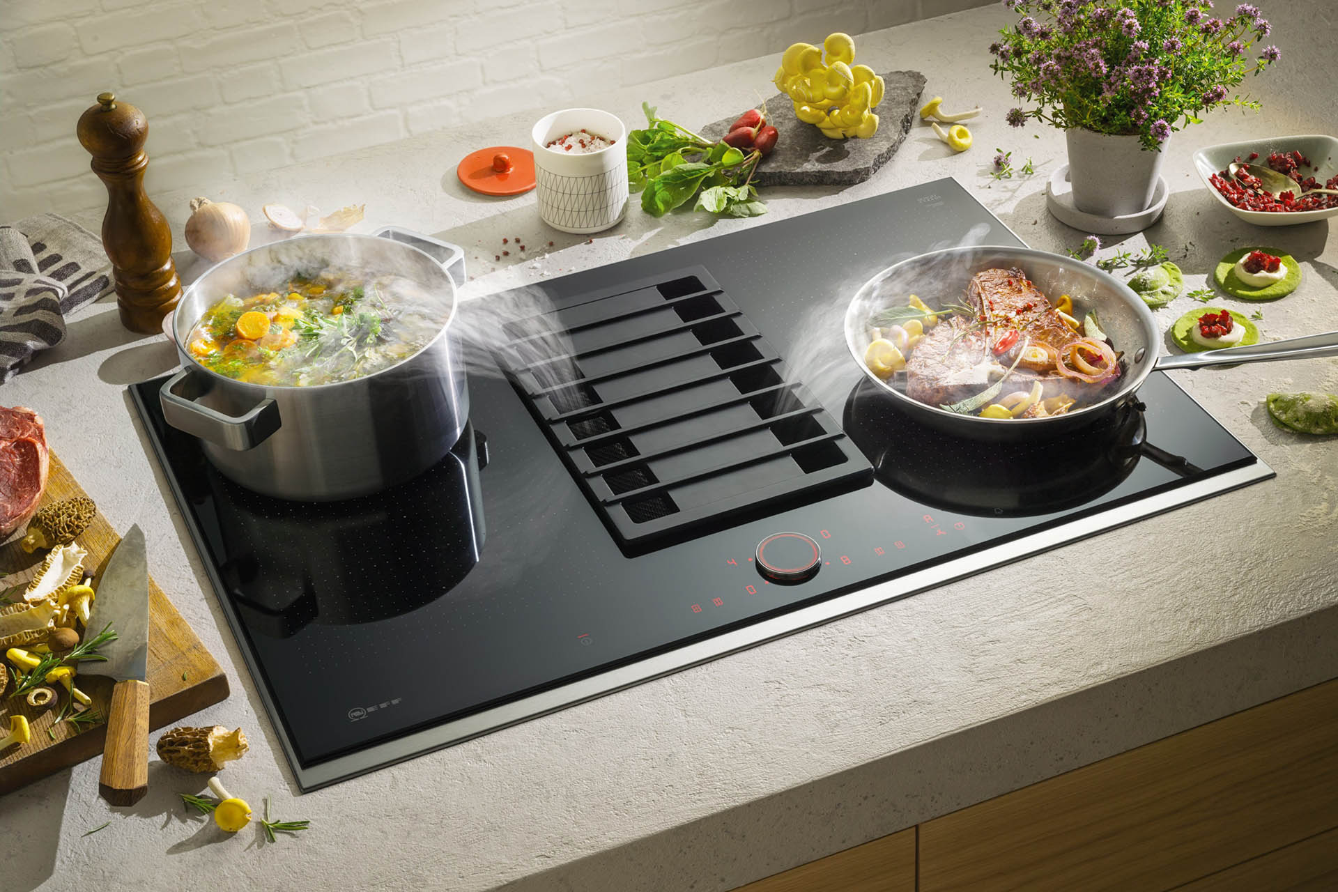 kitchen stove with boilinh vegetable in a pot and cooktop ventilation
