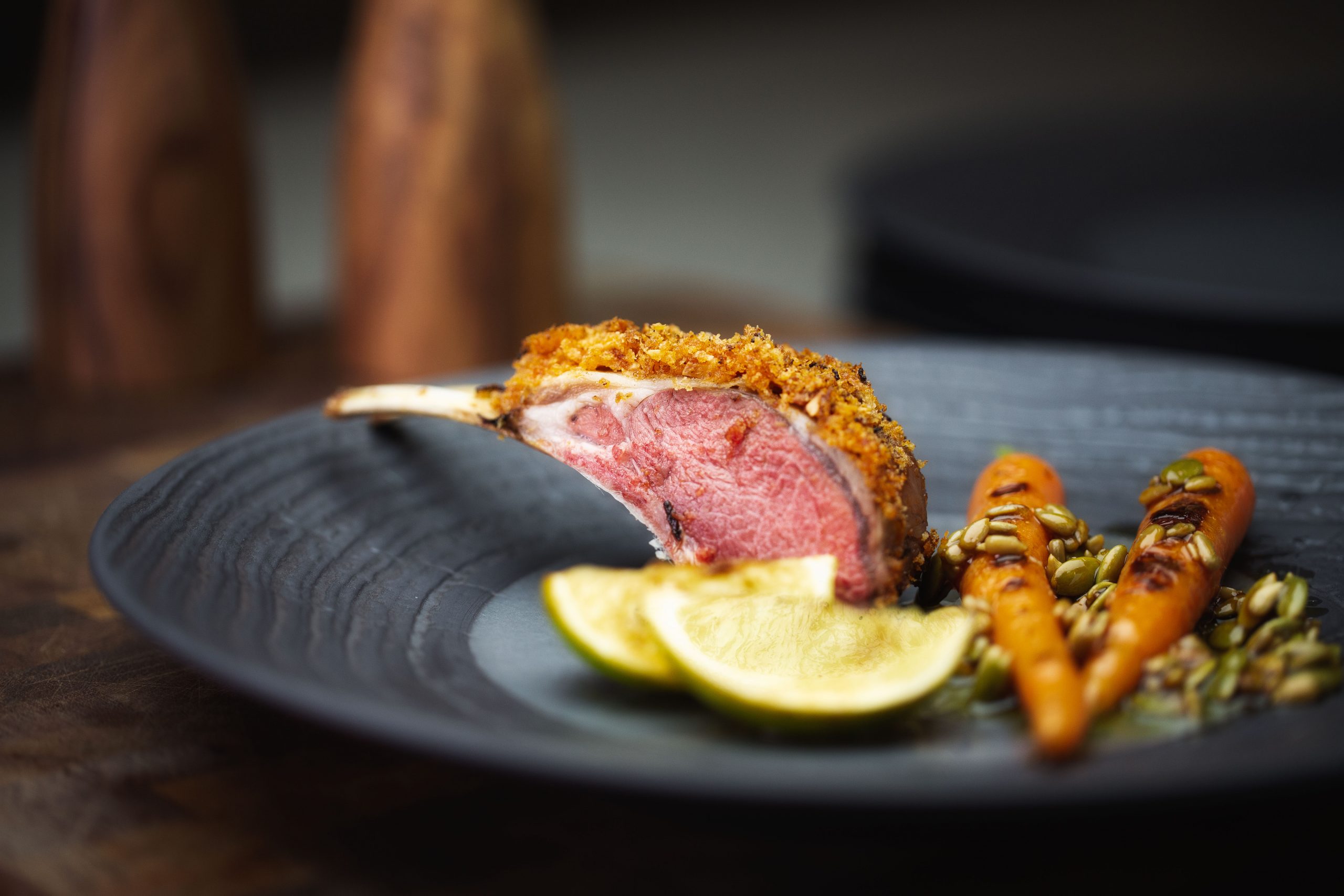 almond crusted lamb with baby carrots and sunflower seed